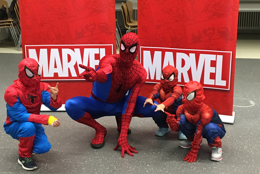 Spiderman mit 3 Kindern in Spiderman-Kostümen